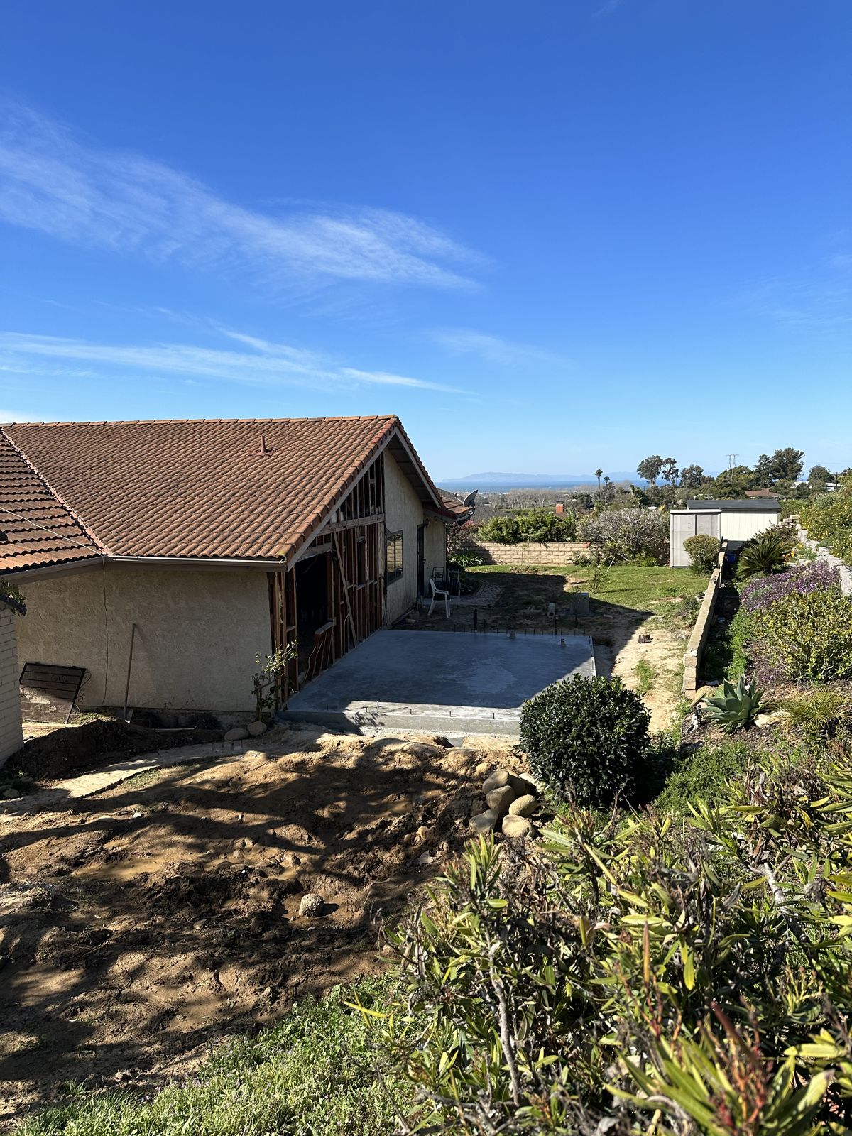 Fresh concrete slab poured for a room addition with an ocean view