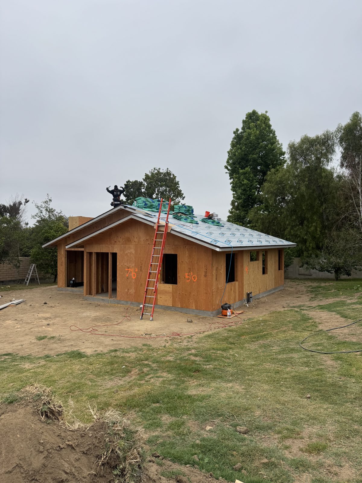 Crew member sheathing the roof of a framed ADU