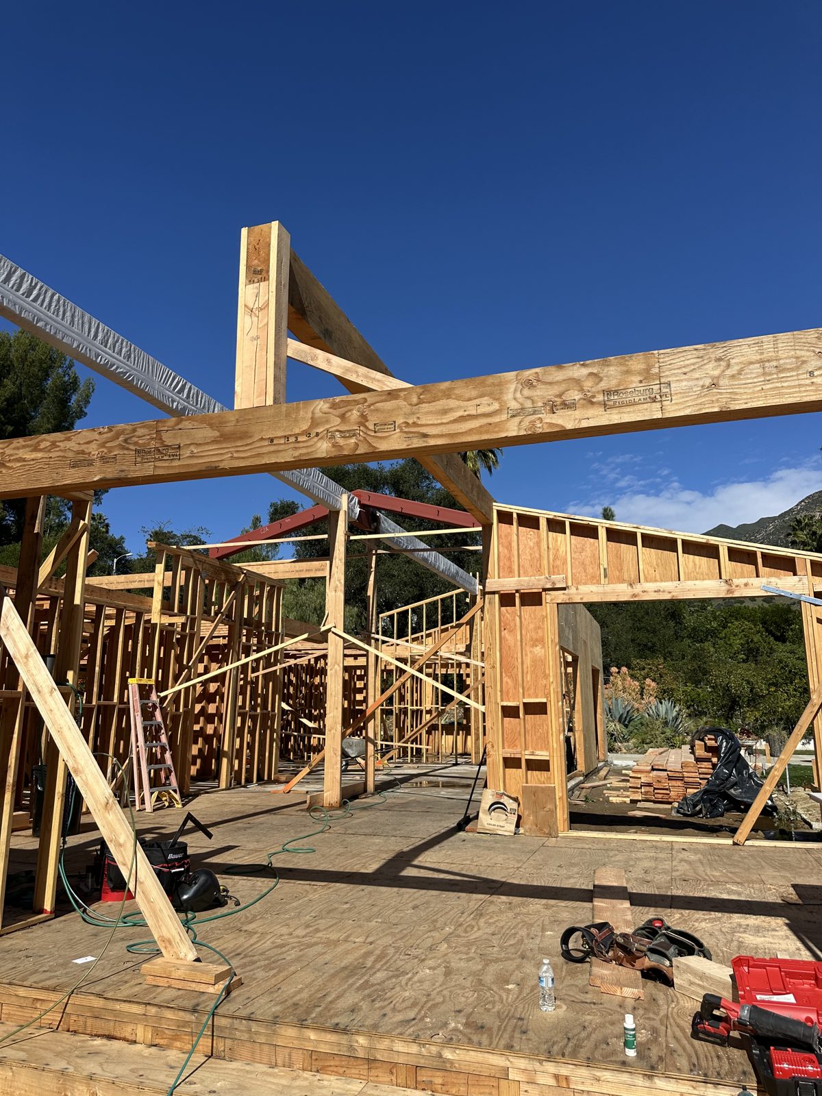 Engineered LVL beams and shear walls under construction on a custom home frame