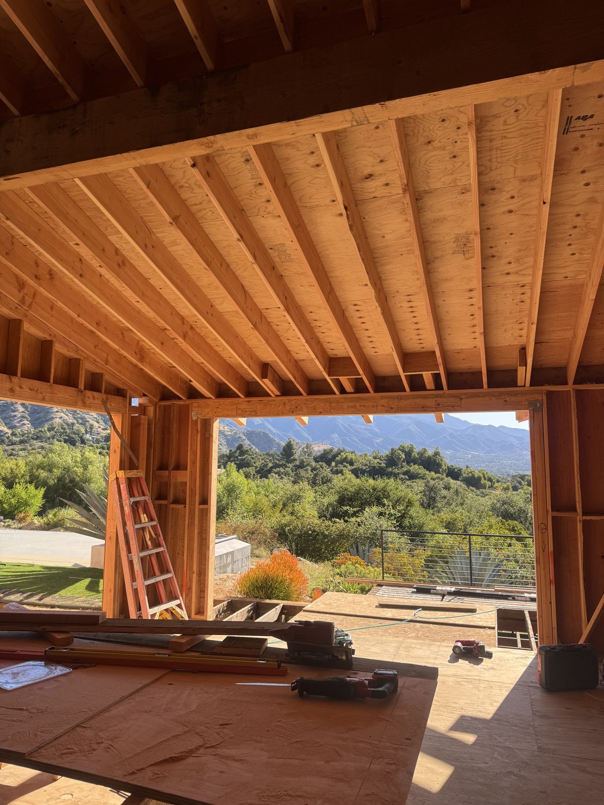 Exposed rafter and beam ceiling framing with mountain views beyond