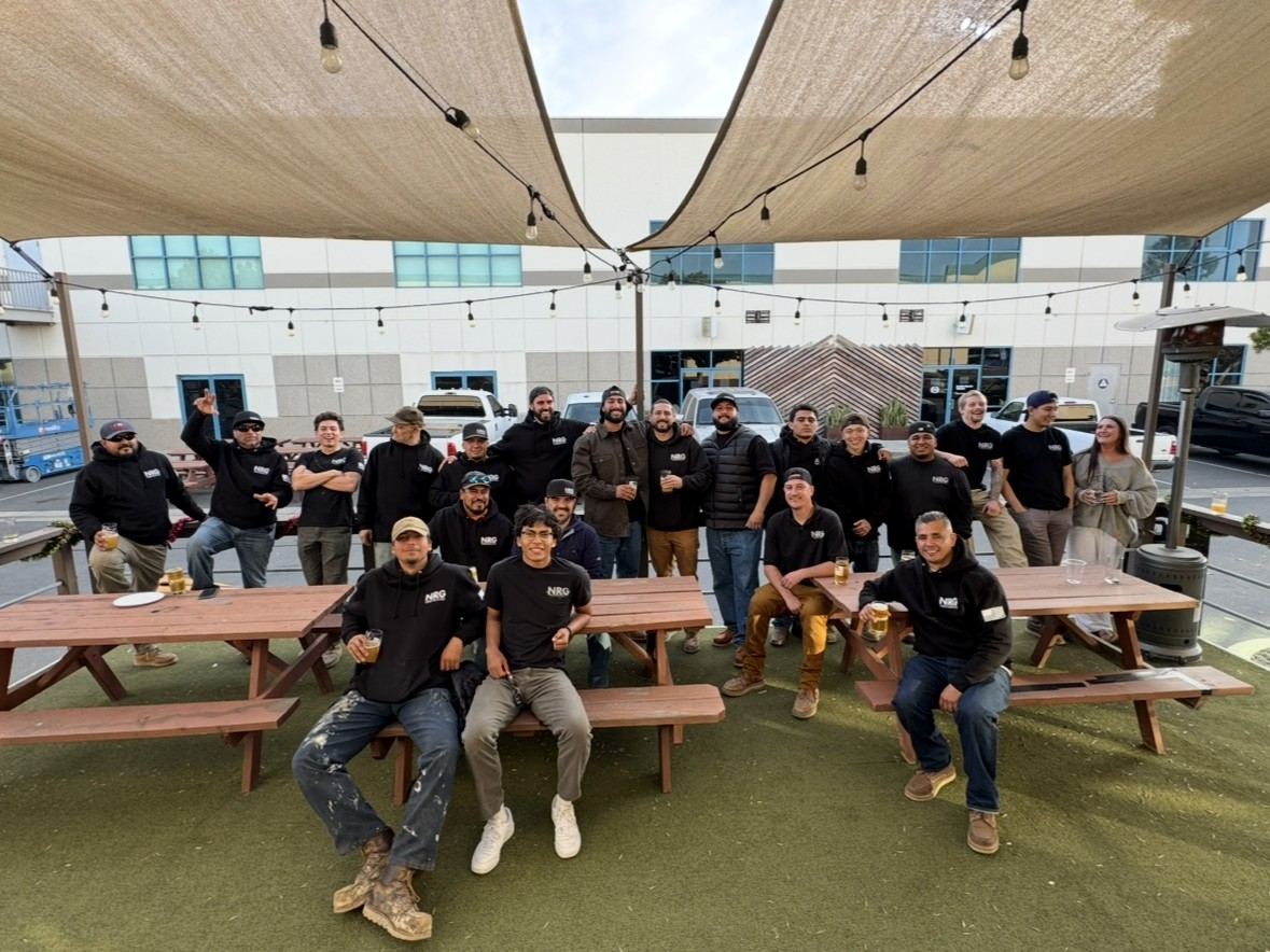 The NRG team gathered around picnic benches after work — the crews behind every NRG Construction project